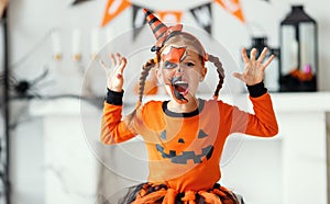 Happy   child girl in pumpkin costume to halloween