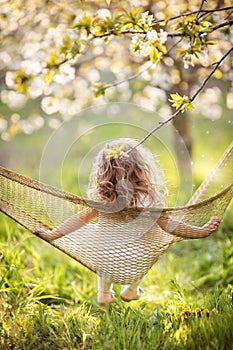Happy child girl relaxing in hammock