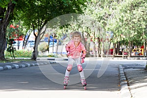 Happy child girl roller skating