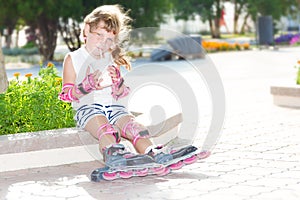 happy child girl roller skating on natural background