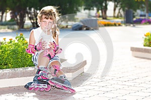 happy child girl roller skating on natural background