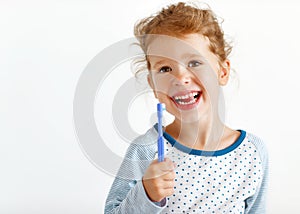 Happy child girl smiles with toothbrush