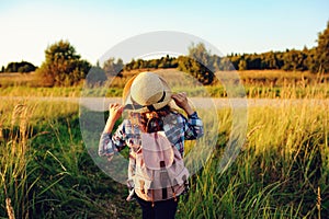 Happy child girl walking on summer countryside. Rural living, exploring new places