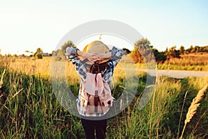 Happy child girl walking on summer countryside. Rural living, exploring new places