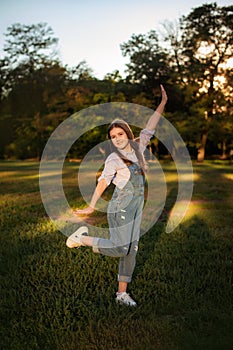 happy child girl walking in summer park - childhood, leisure and people concept. vertical photo