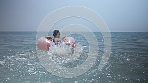 Happy child going to swim in blue sea.