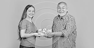 happy child and granddad with present box for anniversary photo
