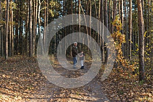 Happy child with Grandfather playing at the forest. Grandpa retiree. Retirement parent. Portrait of pensive senior man  and his