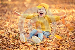 Happy child having fun outdoor in autumn park