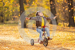 Happy child having fun outdoor in autumn park