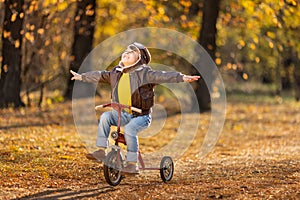 Happy child having fun outdoor in autumn park