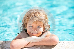 Happy child having fun at swimming pool on sunny day. Boy kid relax in spa swim pool.