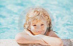 Happy child having fun at swimming pool on sunny day. Boy kid relax in spa swim pool.