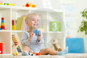 Happy child holding elefant toy photo