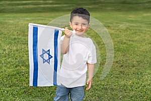 Happy Child Holding Israeli Flag In Park.