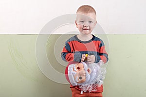 A happy child is holding a Santa Claus mask and an empty banner. Greeting card with Christmas. The concept of Christmas holidays