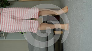 Happy child jumping barefoot on carpet, legs close-up, slow motion.