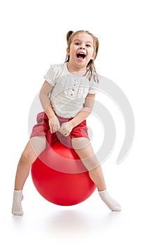 Happy child jumping on bouncing ball