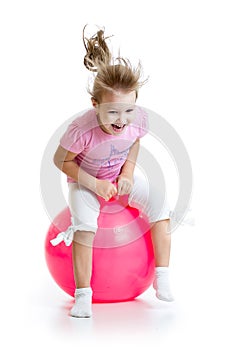 Happy child jumping on bouncing ball