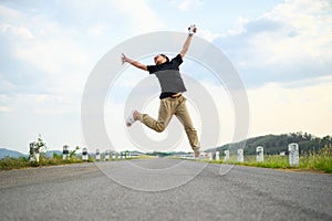 Happy child is jumping on the country road