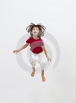 Happy child jumping with energy to express cheerful dynamism, 