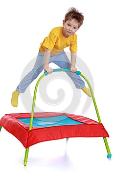 Happy child jumping on a trampoline