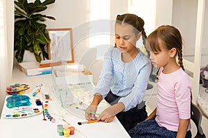 happy child laughs. joyful little girls artist paints a picture