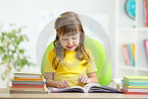 Happy child learning to read in nursery