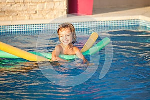 Happy child learning to swim