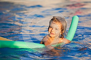 Happy child learning to swim