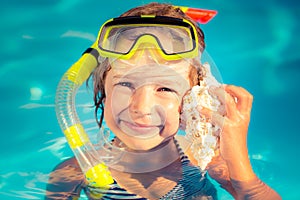 Happy child listen to seashell at the beach