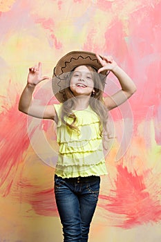 Happy child or little smiling girl in cowboy hat
