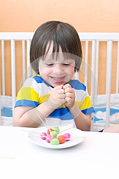 Happy child with lollipops of playdough and toothpicks