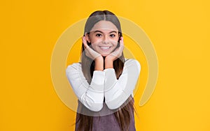 happy child with long hair on yellow background. cheerfulness