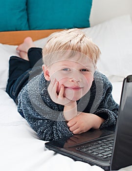 Happy child looking at his laptop