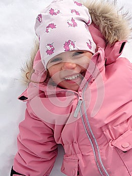 Happy child making a snow angel