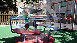 Happy child on merry-go-round in playgroung