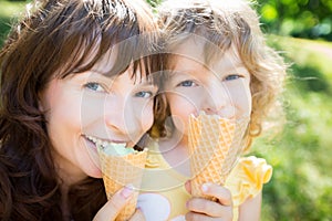 Happy child and mother eating ice cream