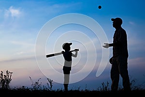 A Happy child with parent playing baseball concept in park in nature