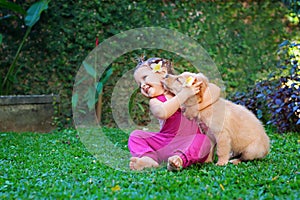 Happy child play and hug family pet - labrador puppy
