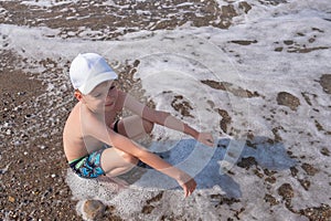 Happy child play in ocean or sea beach. boy vacation