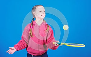 Happy child play tennis in gym staduim. Sport game success. Tennis player with racket and ball. Childhood activity