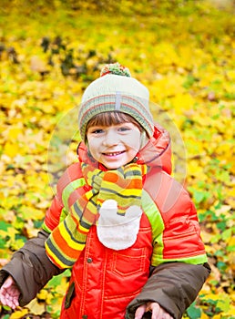 Happy child playing in autumn park