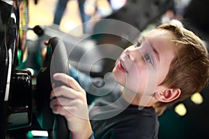 Happy child playing in car simulator