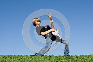 Happy child playing guitar