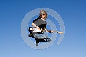 Happy child playing guitar