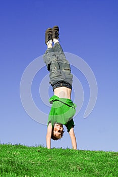 Happy child playing handstand photo