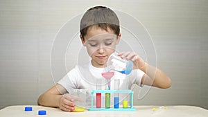 Happy child playing. Kids doing a chemical experiment in laboratory at school. Children laboratory