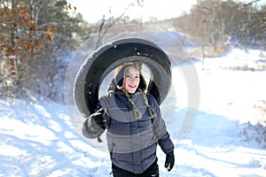 Happy Child Playing Outside Sledding in Snow