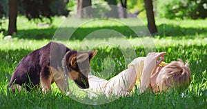 Happy child playing puppy at green park